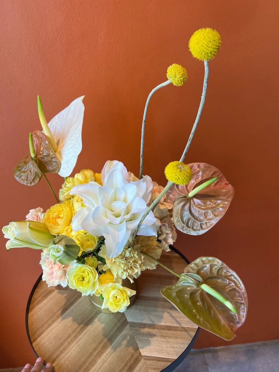 Yellow and white arrangement featuring lily, anthuriums and billy balls in studio