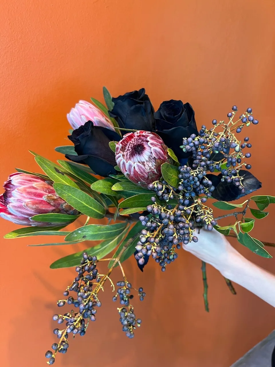 Black rose and protea moody bouquet