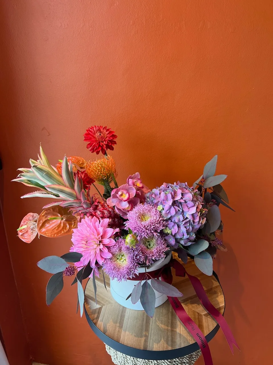 Grand white hatbox with red dahlias, protea, hydrangea and eucalyptus